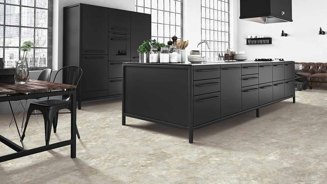 luxury vinyl tile flooring in a large black and white kitchen